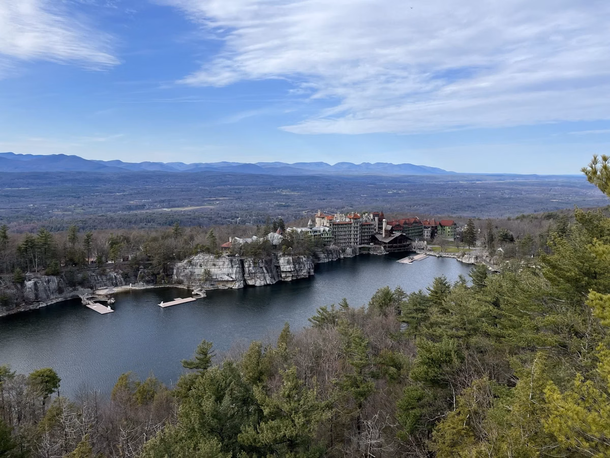 Mohonk Lake and the Mohonk Mountain House resort seen from the ridge, with the valley and Catskills beyond